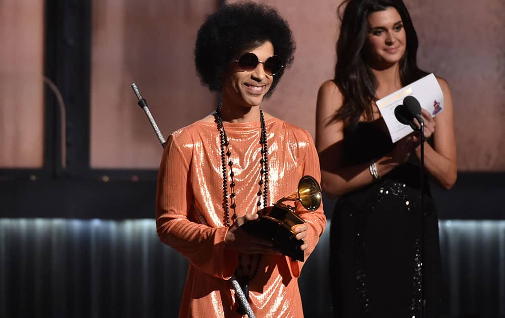 Prince presents the award for album of the year at the 57th annual Grammy Awards.