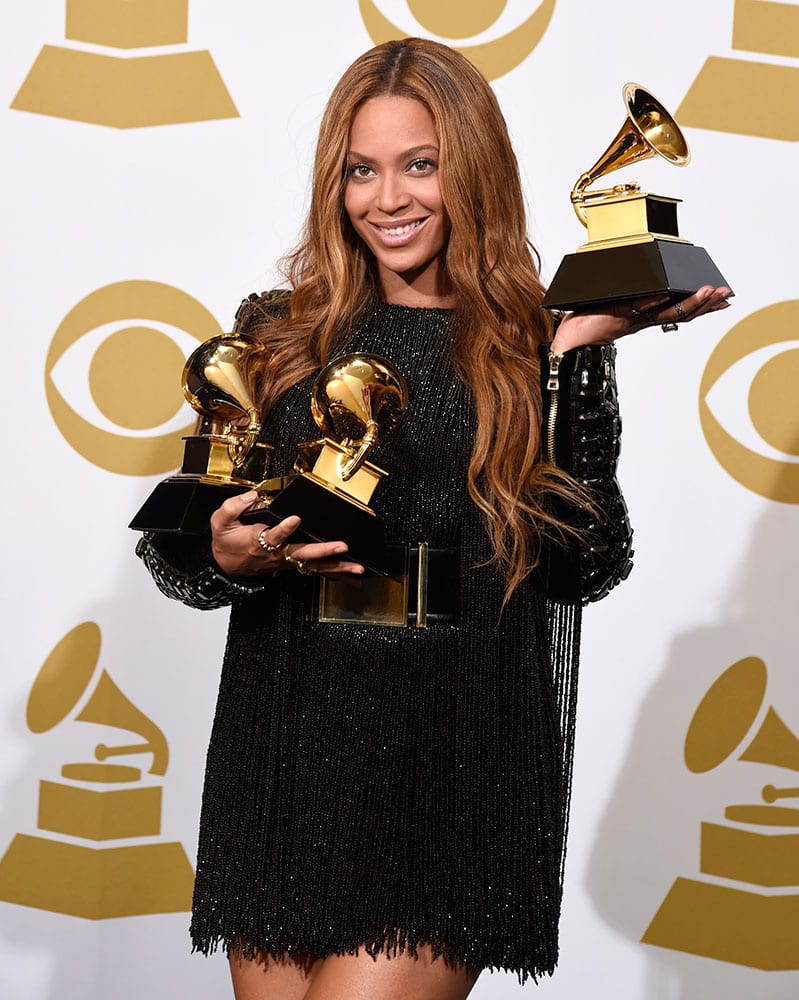 Beyonce poses in the press room with the awards for best R&B performance for “Drunk in Love”, best surround sound album for “Beyonce”, and best R&B song for “Drunk in Love” at the 57th annual Grammy Awards.