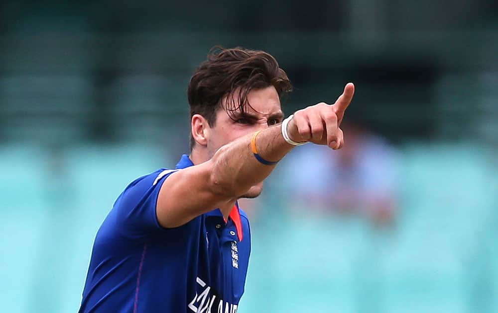 England bowler Steven Finn points as he makes an unsuccessful appeal for a wicket during their Cricket World Cup warm-up match against the West Indies in Sydney.