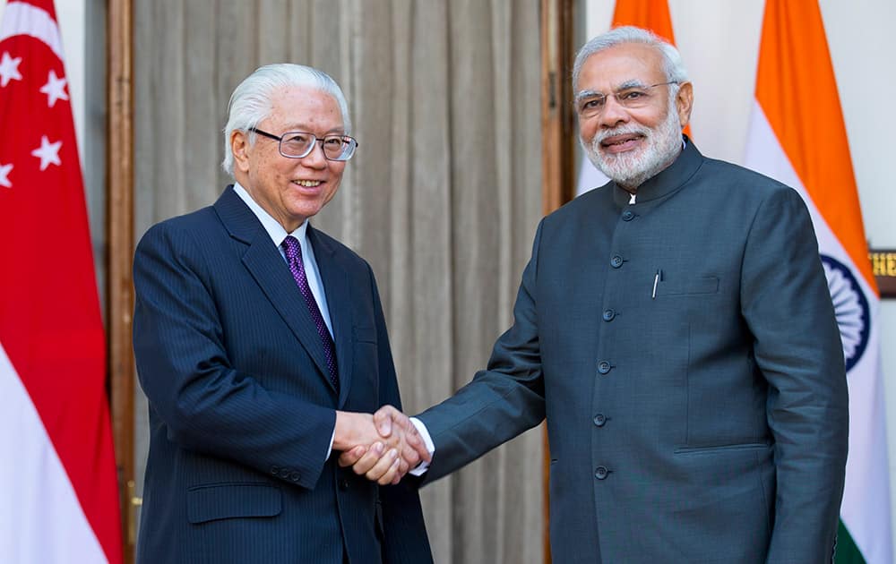 Indian Prime Minister Narendra Modi, right, poses with Singapore's President Tony Tan Keng Yam for photographers in New Delhi, India, Monday. Tan Keng Yam is on a three-day official visit to the country.