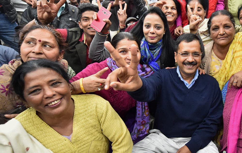 AAP Convener Arvind Kejriwal in a cheerful mood with party volunteers at a meeting in New Delhi, a day before counting of votes for Delhi polls.