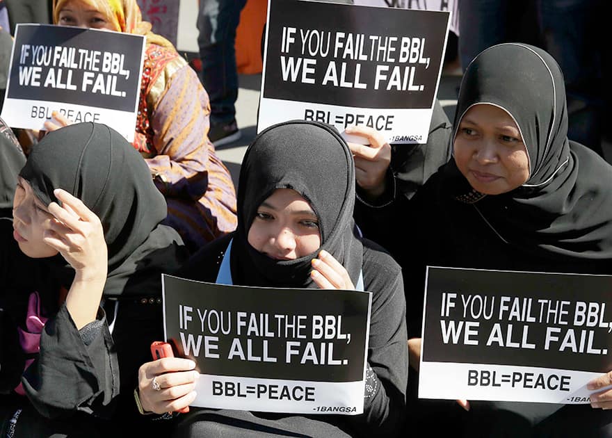 Filipino Muslims display messages during a rally at the Lower House to call for the passage of Bangsamoro Basic Law, or BBL in southern Philippines.