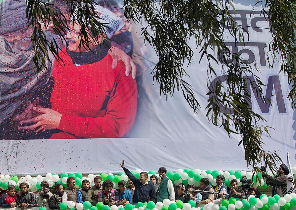 Leader of the Aam Aadmi Party, Arvind Kejriwal, waves to the crowd as his party looks set for a landslide party in New Delhi.