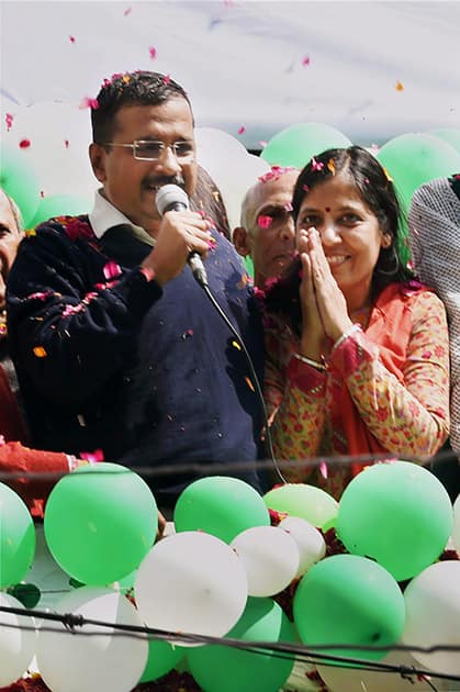 AAP convener thanks his wife for her support as he addresses the party volunteers during a programme to celebrate the partys victory in the Delhi Assembly polls, at Patel Nagar in New Delhi.