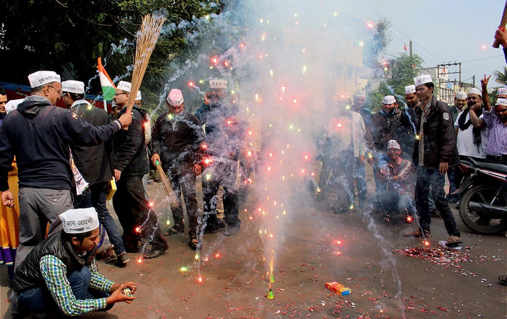 Aam Adami Party workers celebrate in Bhopal on Tuesday the partys landslide victory in Delhi state assembly elections. 