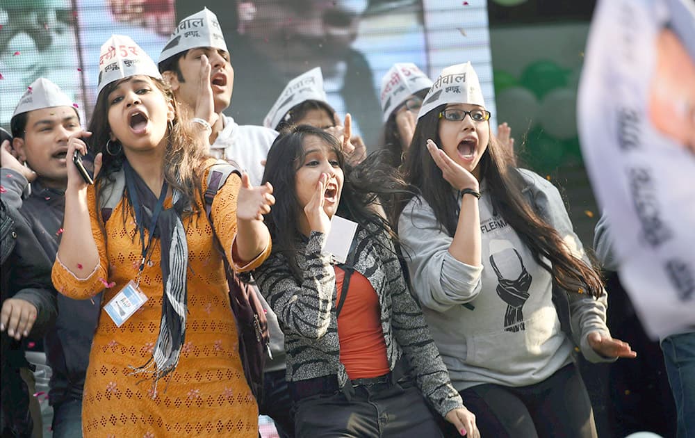 AAP volunteers celebrate the partys victory in the Delhi Assembly polls, at Patel Nagar in New Delhi.