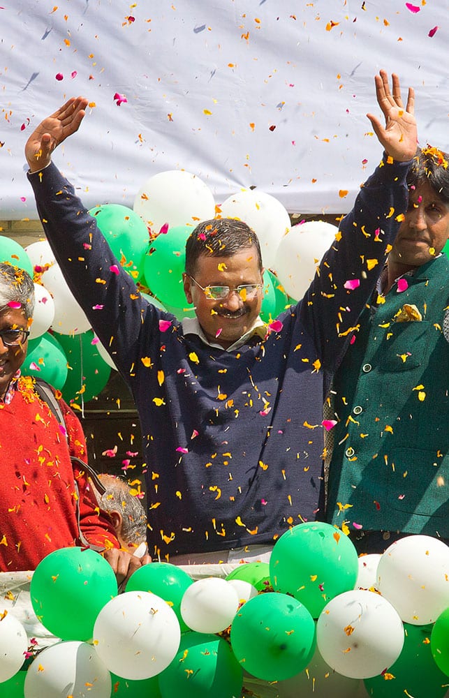 Leader of the Aam Aadmi Party, or Common Man’s Party, Arvind Kejriwal waves to the crowd as his party looks set for a landslide party in New Delhi, India.