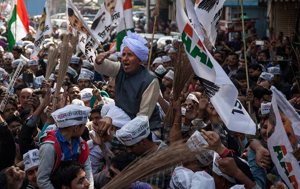 An elderly supporter of the Aam Aadmi Party celebrates his party's victory in New Delhi.