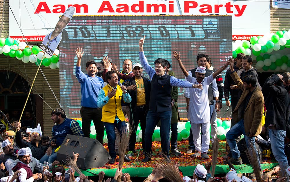 Supporters of Aam Aadmi Party celebrate as their party looks set for a landslide victory in New Delhi.