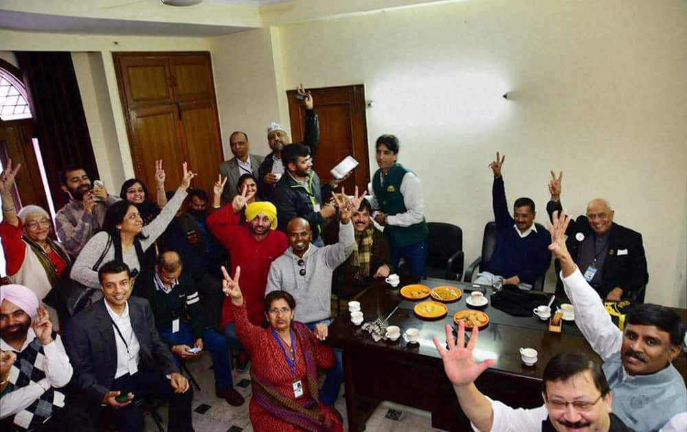 AAP convener Arvind Kejriwal and other party leaders celebrate their win in the Assembly polls, at party office in New Delhi.