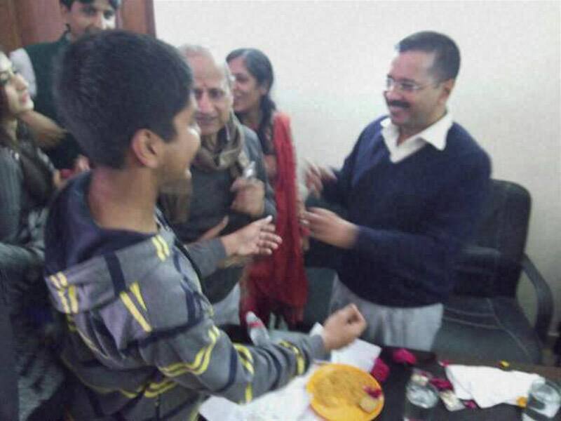 AAP convener Arvind Kejriwal celebrates with his family members after the early counting trends showed the partys win in the Assembly polls, at his residence in Kaushambi.