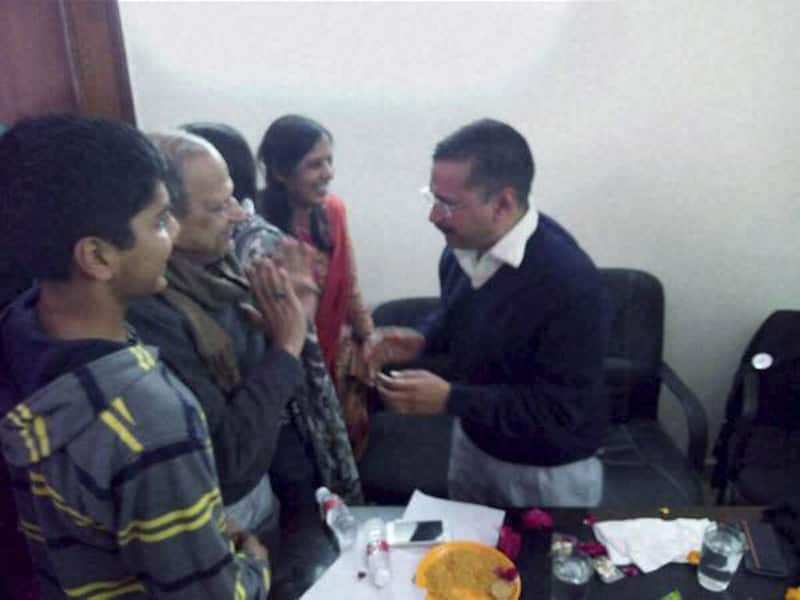 AAP convener Arvind Kejriwal celebrates with his family members after the early counting trends showed the partys win in the Assembly polls, at his residence in Kaushambi.