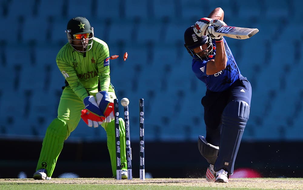 Pakistan's wicketkeeper Umar Akmal, looks on as England's Ravi Bopara is clean bowled during their Cricket World Cup warm-up match in Sydney, Australia.