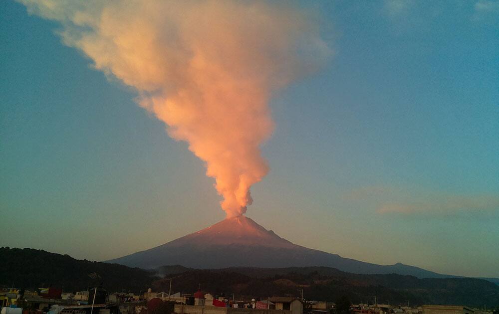 A large plume of ash and steam rises from the Popocatepetl volcano, as seen from the town of San Nicolas de los Ranchos, Mexico.