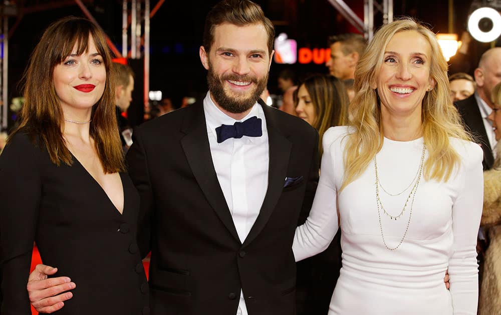 Actress Dakota Johnson, actor Jamie Dornan and director Sam Taylor-Johnson, from left, pose for photographers on the red carpet for the world premiere of Fifty Shades of Grey at the 2015 Berlinale Film Festival.