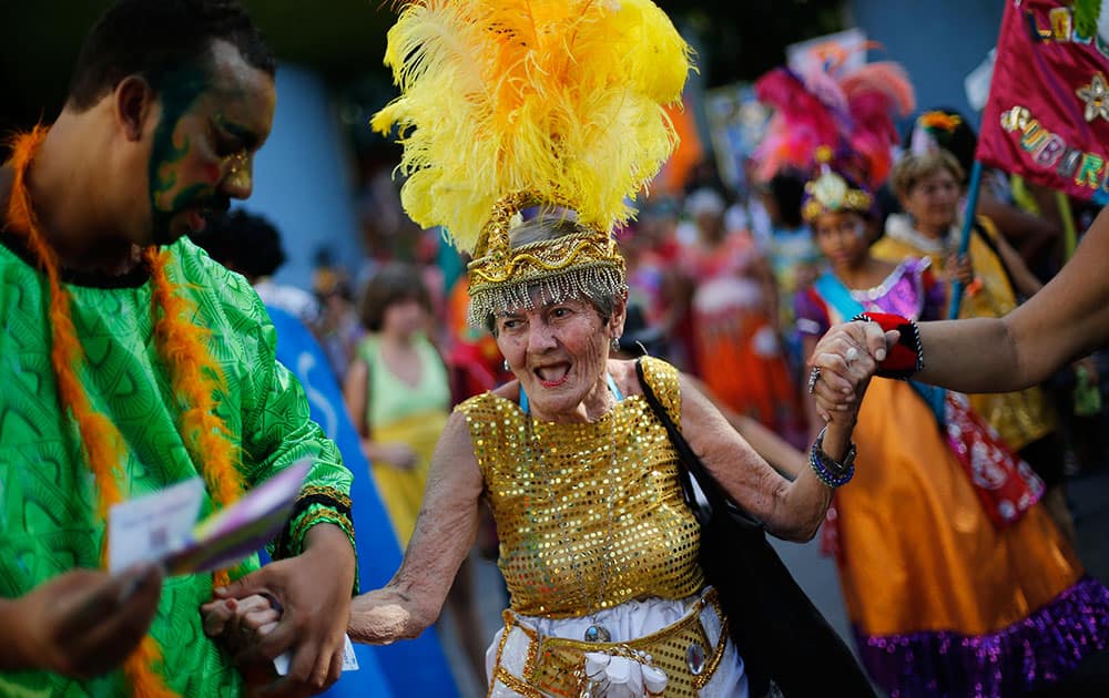 An elderly patient in costume from the Nise de Silveira mental health institute dances during the institute's carnival parade, coined in Portuguese: 