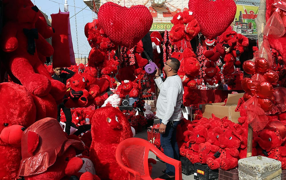 A shop owner cleans his merchandise ahead of Valentine's Day at the Karrada neighborhood of Baghdad, Iraq.