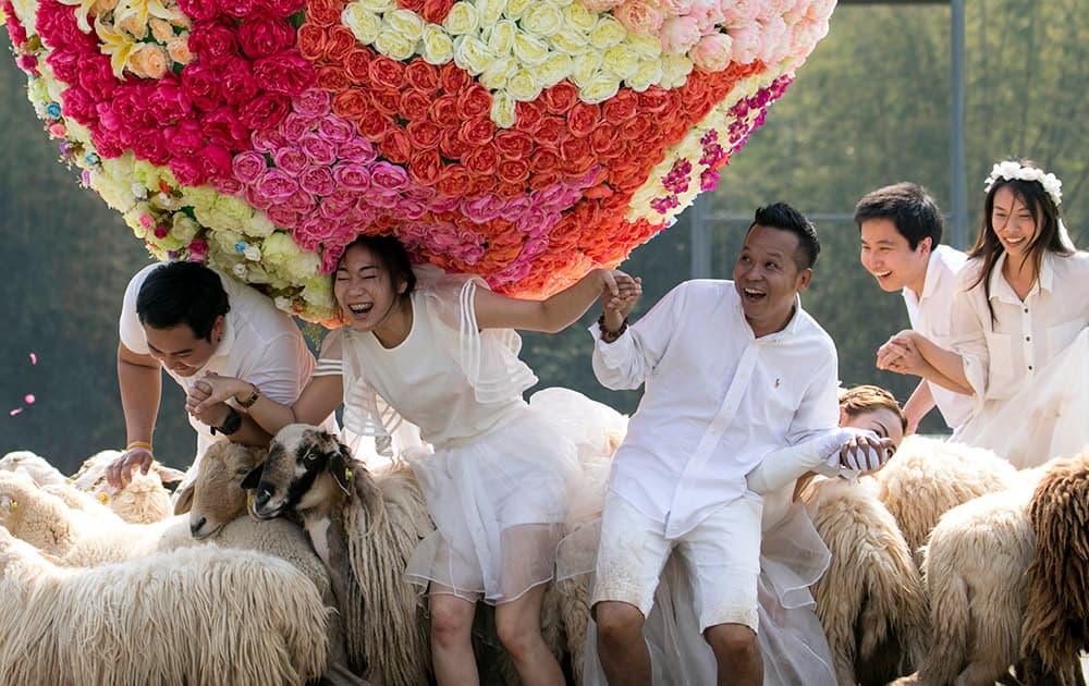 Three newlywed couples frolic at a resort in Ratchaburi province in western Thailand.