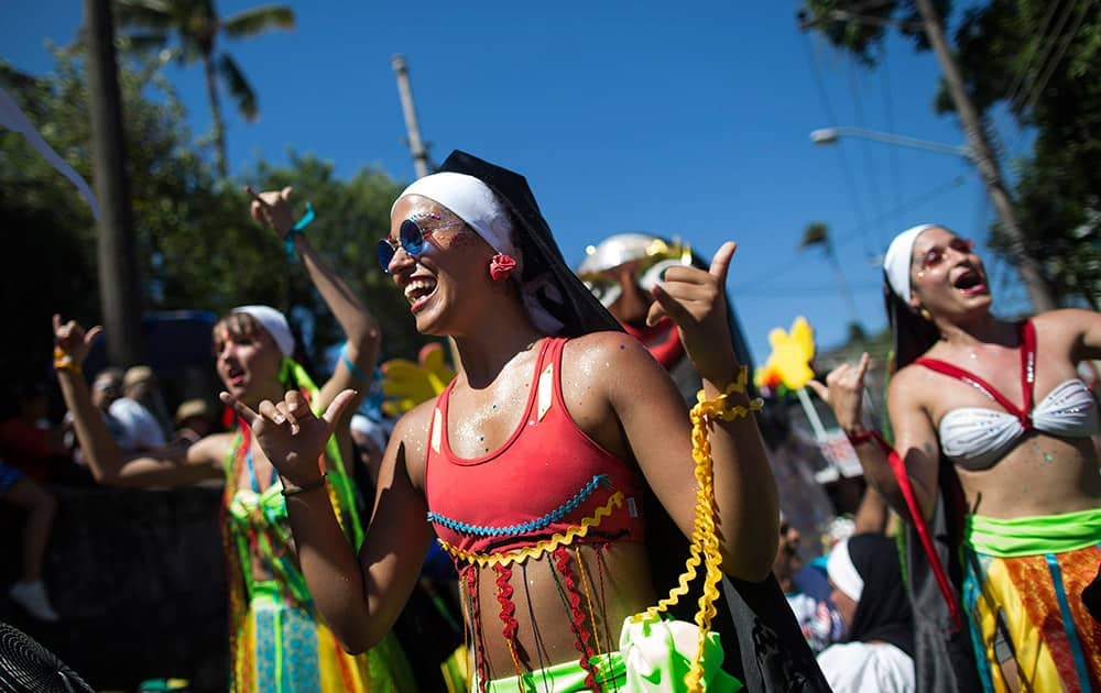 Revelers perform during the 'Carmelitas' carnival parade in Rio de Janeiro, Brazil.