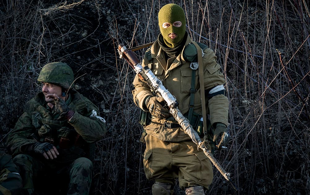 Russian-backed separatists wait for their transport, preparing to leave towards the frontline, in the village of Vergulivka, just outside Debaltseve, eastern Ukraine.