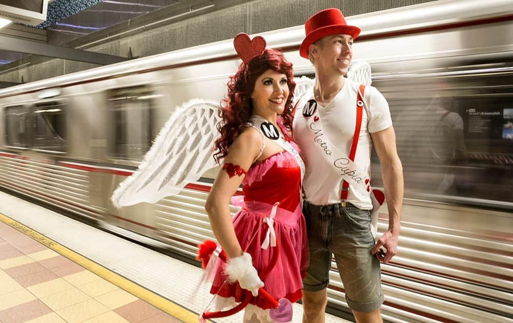 Performers Shauna Hackney and Jared Hansen, dressed as 'Metro Cupids,' await the 'Speed Dating' car on the Red Line train heading to North Hollywood in Los Angeles.