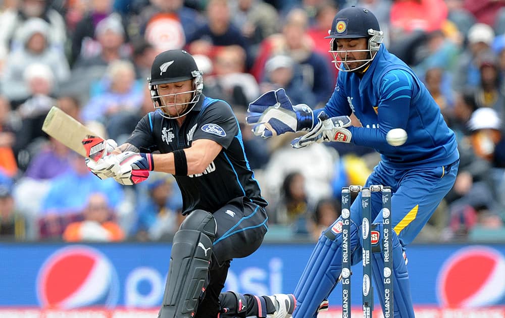 New Zealand's Brendon McCullum, left, sweeps the ball in front of Sri Lanka's Kumar Sangakkara during the opening match of the Cricket World Cup at Christchurch, New Zealand.