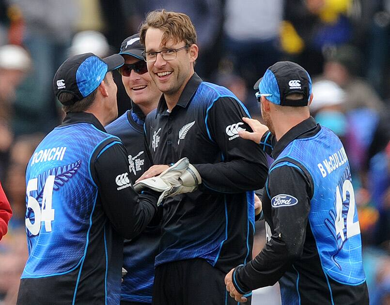 Teammates congratulate New Zealand's Daniel Vettori, after catching out, off his own bowling, Sri Lanka's Tillakaratne Dilshan for 24 runs during the opening match of the Cricket World Cup at Christchurch, New Zealand.