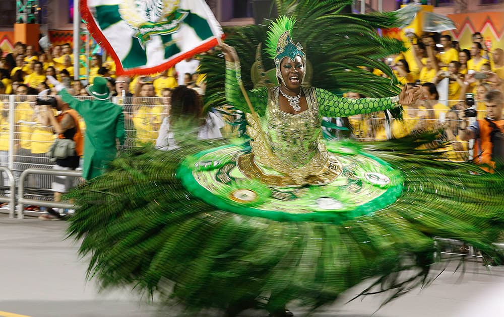 A dancer from the Mancha Verde samba school performs during the Carnival parade at the Sambodromo in Sao Paulo, Brazil.