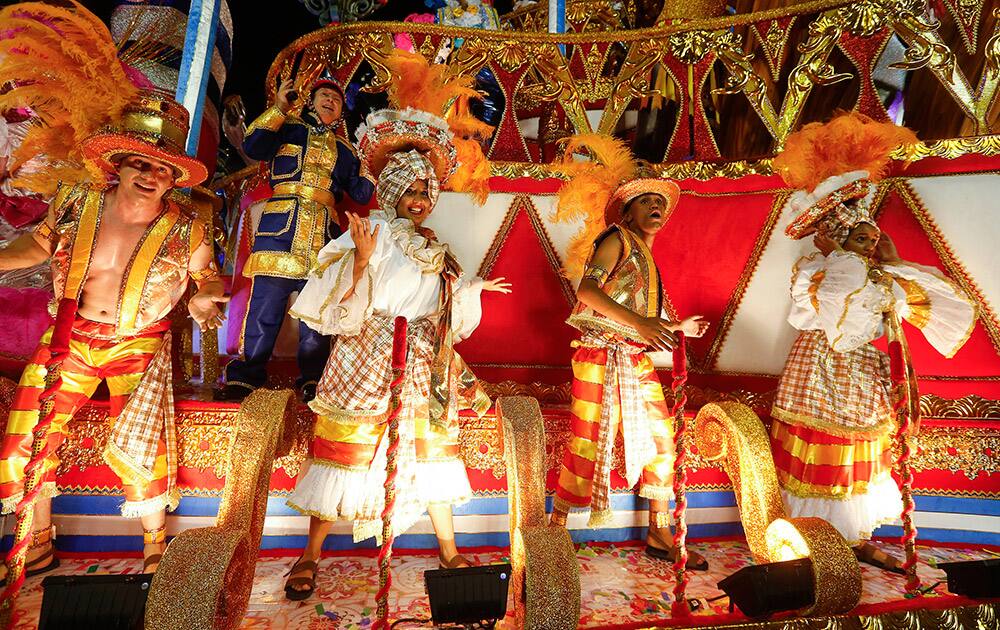 Dancers from the Academicos do Tucuruvi samba school perform on a float during the Carnival parade at the Sambodromo in Sao Paulo.