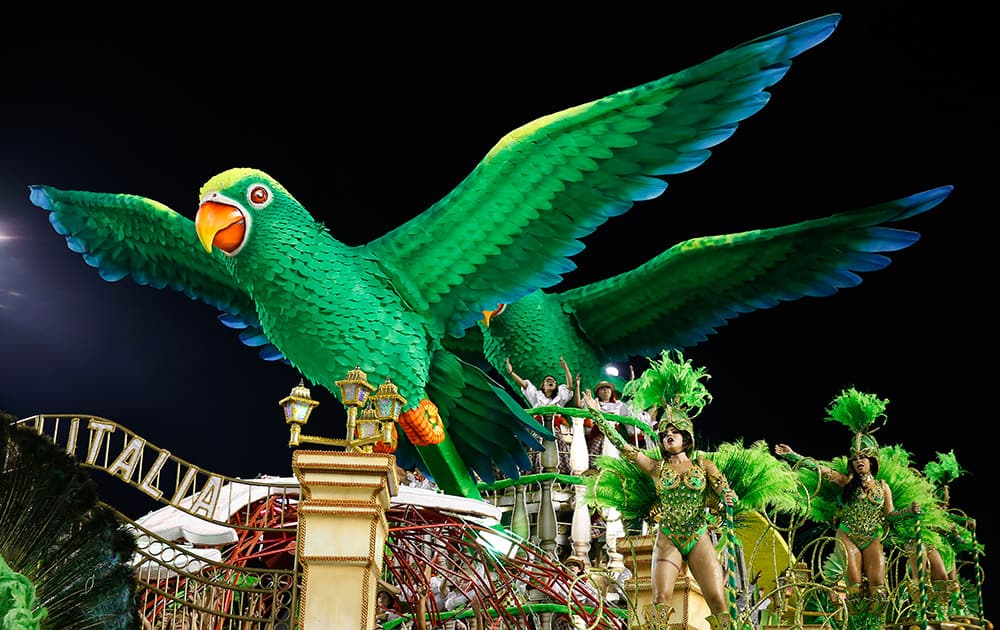 Dancers from the Mancha Verde samba school perform on a float during the Carnival parade at the Sambodromo in Sao Paulo, Brazil.