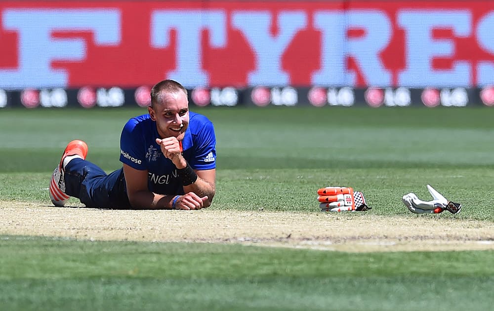 England bowler Stuart Broad lies on the pitch smiling after he collided midwicket with Australia batsman David Warner during their cricket world cup pool A match in Melbourne, Australia.