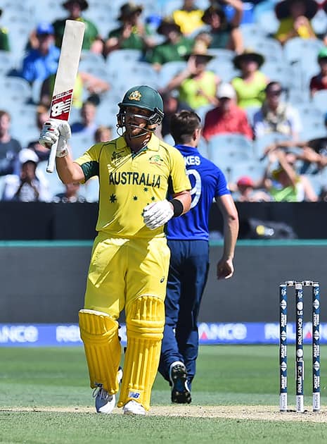 Australia batsman Aaron Finch raises his bat after he hit a half century during their cricket world cup pool A match against England in Melbourne, Australia.