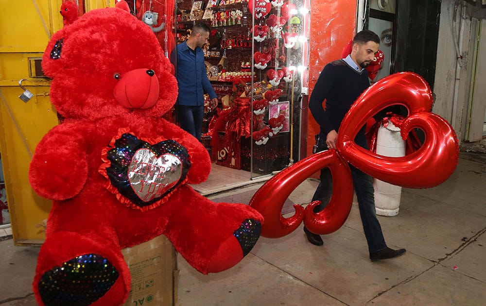 A man leaves a shop with a gift he bought for the upcoming Valentine's Day in central Baghdad.