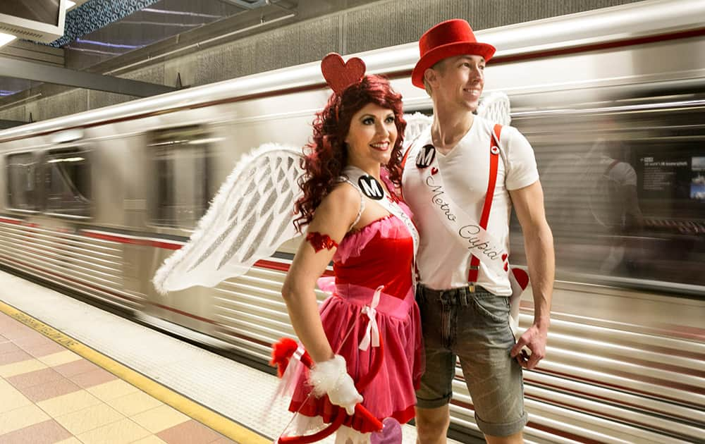 Performers Shauna Hackney and Jared Hansen, dressed as 'Metro Cupids,' await the 'Speed Dating' car on the Red Line train heading to North Hollywood in Los Angeles.