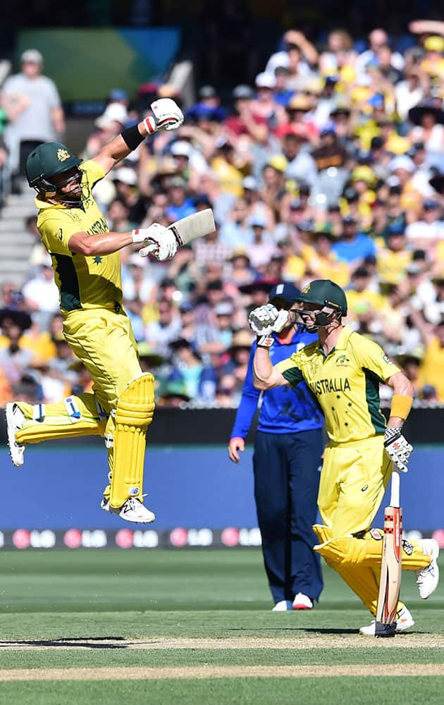 Australia's Aaron Finch, leaps high as he celebrates hitting a century during their cricket world cup pool A match against England in Melbourne, Australia, Saturday.