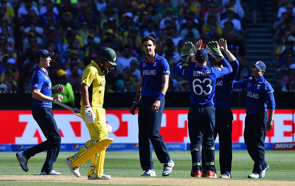 Australia's Aaron Finch, walks past as England's team celebrates running him out during their Cricket World Cup pool A match in Melbourne, Australia, Saturday.