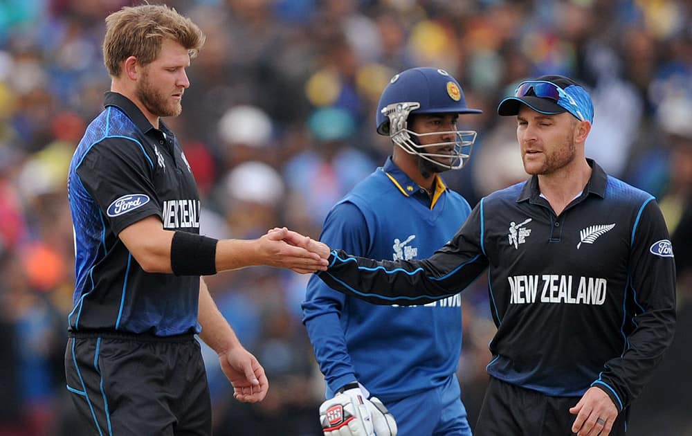 New Zealand's Corey Anderson  and Grant Elliott, celebrate after combining to take the wicket of Sri Lanka's Nuwan Kulasekara, for 10 runs during the opening match of the Cricket World Cup at Christchurch, New Zealand.