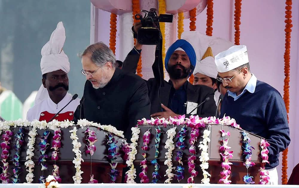 Lieutenant Governor Najeeb Jung administers the oath of office and secrecy to Delhi Chief Minister Arvind Kejriwal at the swearing-in ceremony at Ramlila Maidan in New Delhi.