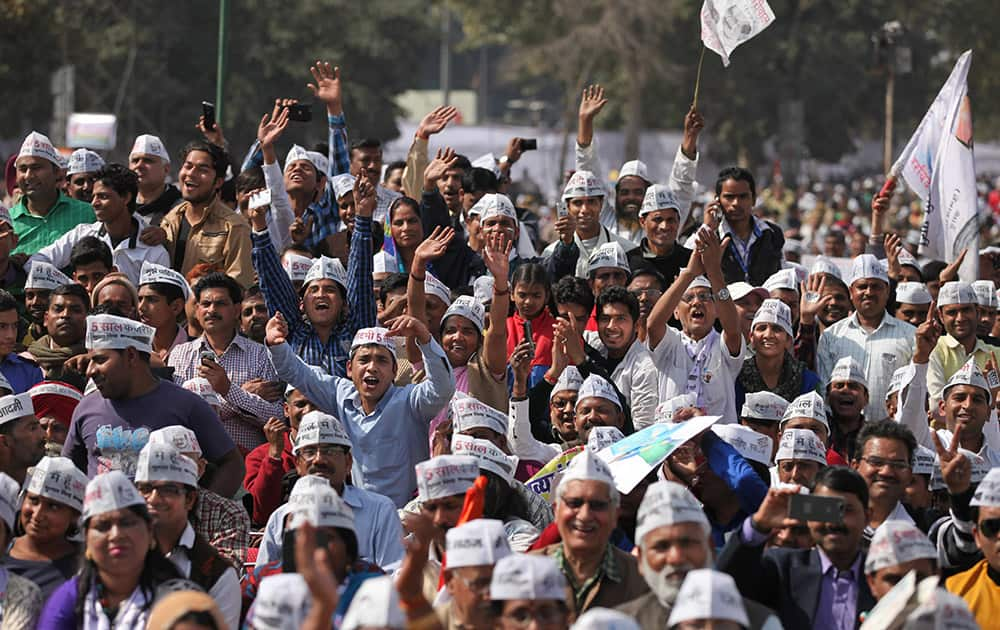 Supporters of Aam Aadmi Party, cheer during the swearing-in ceremony of party leader Arvind Kejriwal as chief minister of Delhi in New Delhi.