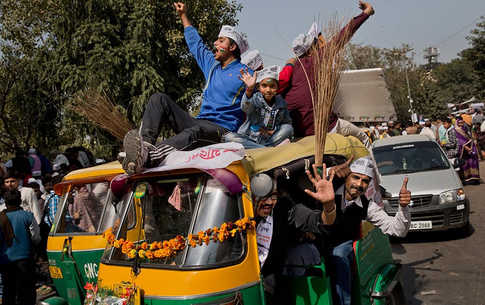 Supporters of the Aam Aadmi Party, shout slogans outside the venue where party leader Arvind Kejriwal is being sworn-in as the new chief minister of Delhi, in New Delhi.