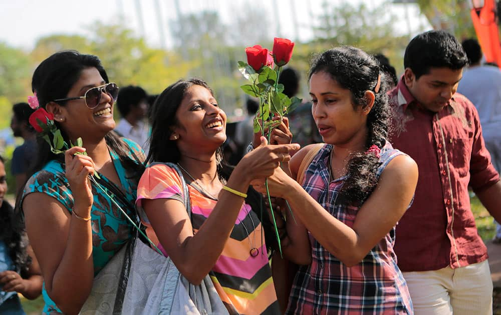 Sri Lankan girls hold roses and attend an event organized to celebrate Valentine's Day in Colombo, Sri Lanka.