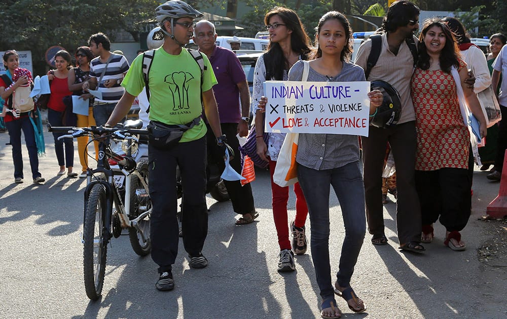 An activist holds a placard and joins others in a protest against moral policing by religious groups, on Valentine's Day in Bangalore.