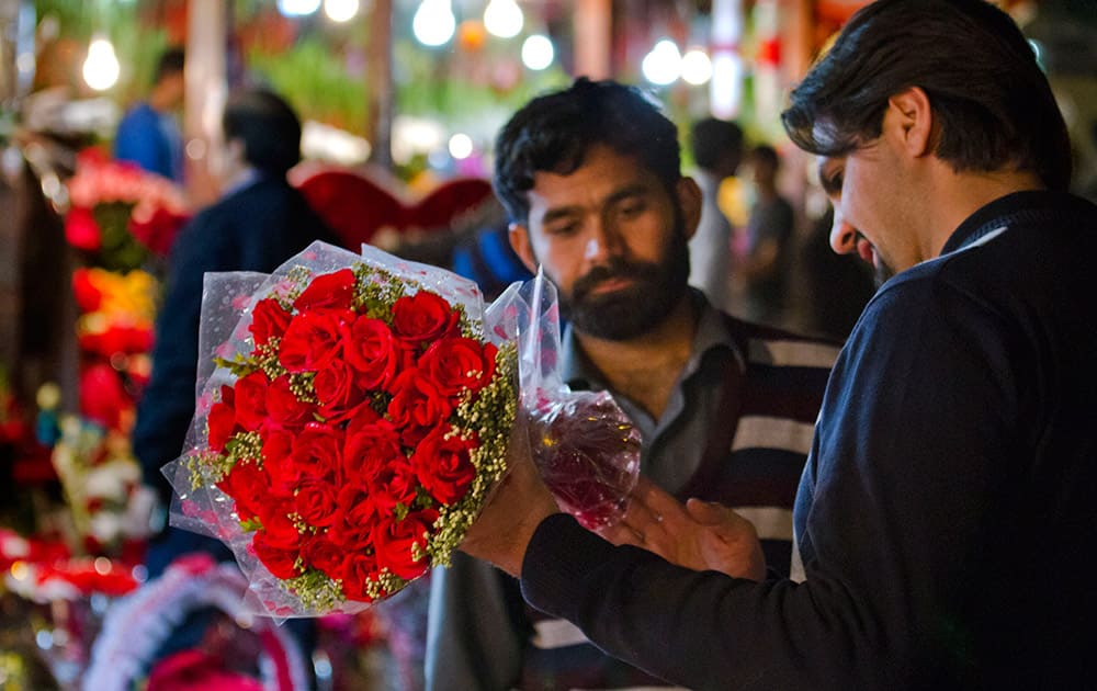 A Pakistani buys a bouquet of flowers at a market on Valentine's Day in Islamabad, Pakistan.