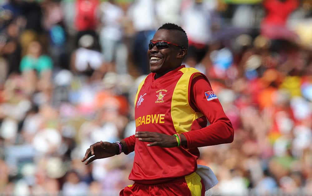 Zimbabwe Tafadzwa Kamungozi smiles after taking the wicket of South Africa's AB de Villiers for 25 runs during their Cricket World Cup pool B match at Hamilton.