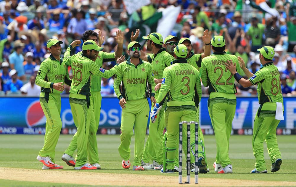 Pakistan players celebrate the wicket of India's Rohit Sharma during the World Cup Pool B match in Adelaide, Australia.