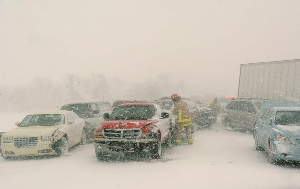 Cars and trucks rest in the median and west-bound lanes of U.S. 30 at the scene of a multi-vehicle crash just west of Columbia City, Ind.