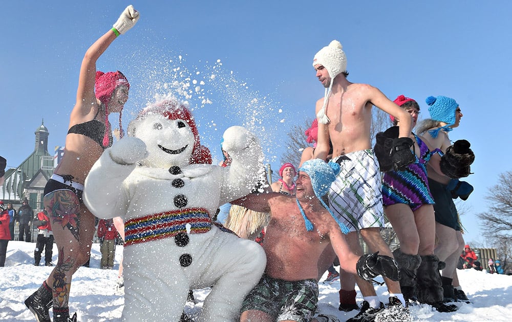 People join Bonhomme Carnaval at the annual snow bath at the Winter Carnival, in Quebec City, Quebec..