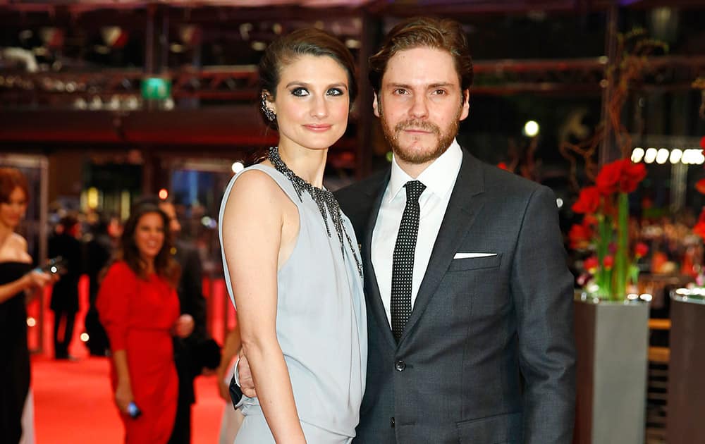 Actor Daniel Bruhl and girlfriend Felicitas Rombold pose for photographers on the red carpet for the award ceremony at the 2015 Berlinale Film Festival in Berlin.