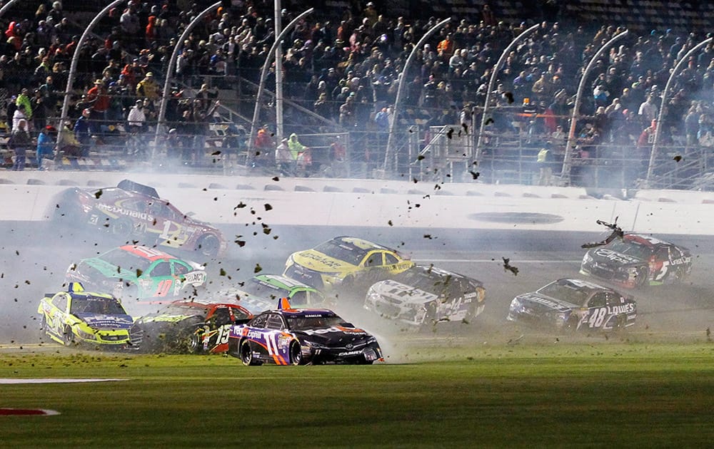 Denny Hamlin (11), Clint Bowyer (15) and others are involved in a multi-car crash on the front stretch during the NASCAR Sprint Unlimited auto race at Daytona International Speedway, in Daytona Beach, Fla. 