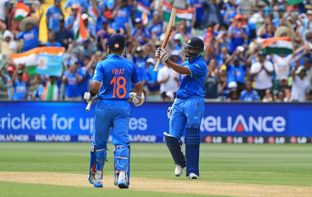 India's Shikhar Dhawan, acknowledges his fifty runs during the World Cup Pool B match against Pakistan in Adelaide.